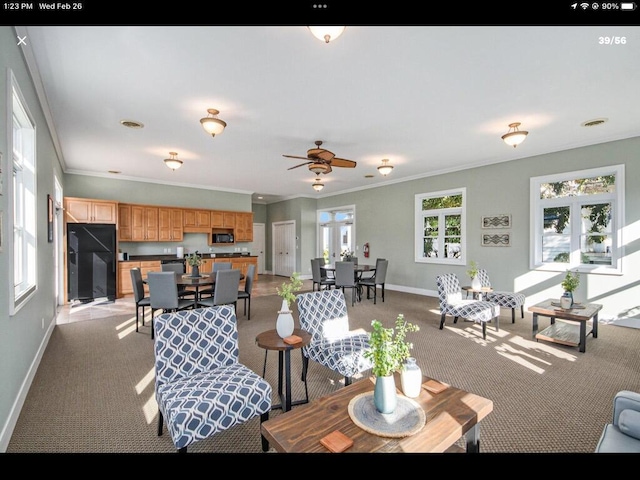 living room featuring light carpet, baseboards, and ornamental molding