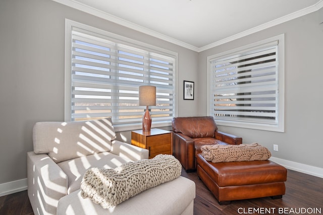 sitting room with baseboards, crown molding, and wood finished floors
