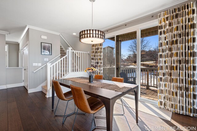dining space featuring crown molding, stairway, baseboards, and hardwood / wood-style flooring