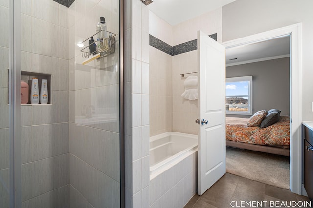 bathroom with ensuite bathroom, a relaxing tiled tub, a tile shower, and tile patterned flooring