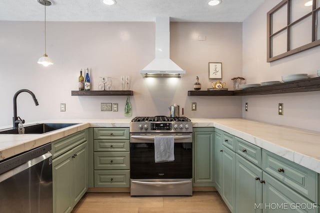 kitchen featuring light countertops, wall chimney range hood, open shelves, and stainless steel appliances