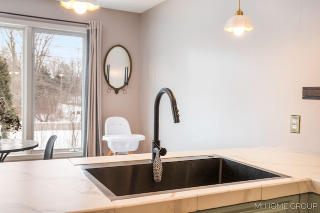 details featuring light countertops, a sink, and decorative light fixtures