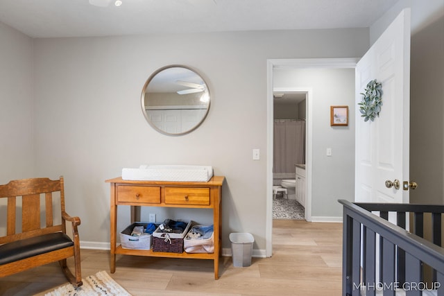 bedroom featuring light wood-style flooring and baseboards