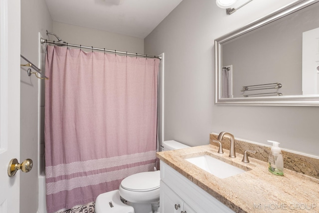 bathroom with vanity, toilet, and shower / bath combo with shower curtain