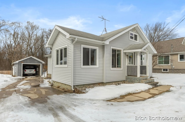 bungalow-style house with an outdoor structure and a detached garage