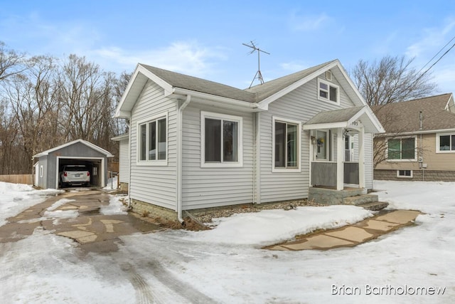 bungalow-style home with a detached garage and an outdoor structure