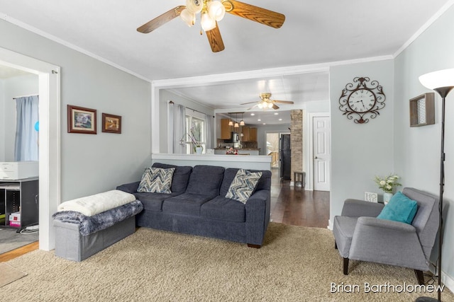 living room featuring a ceiling fan, crown molding, and wood finished floors