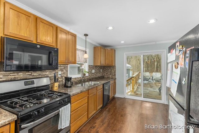 kitchen with ornamental molding, brown cabinets, a sink, and black appliances