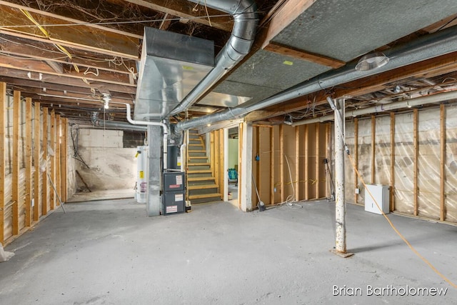 unfinished below grade area featuring water heater and stairs