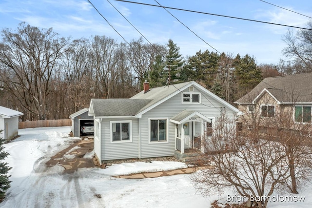 view of front of house featuring a chimney and roof with shingles