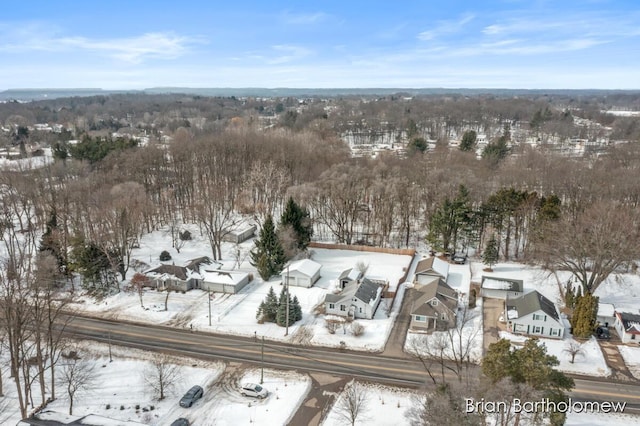 snowy aerial view with a residential view