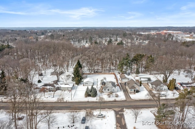 snowy aerial view featuring a residential view