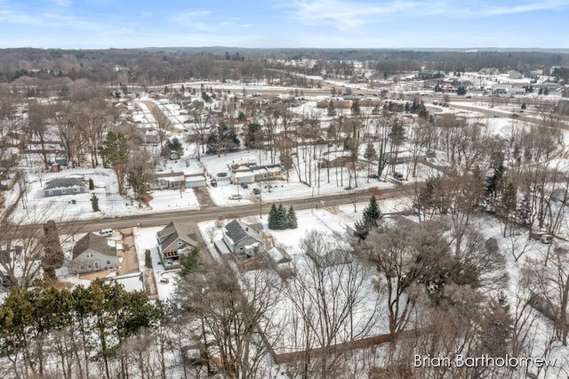 snowy aerial view with a residential view