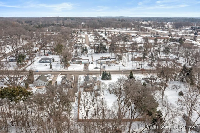 snowy aerial view with a residential view