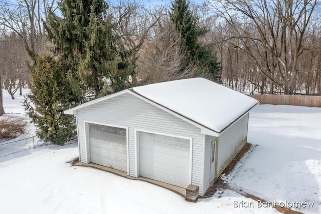 snow covered garage with a garage