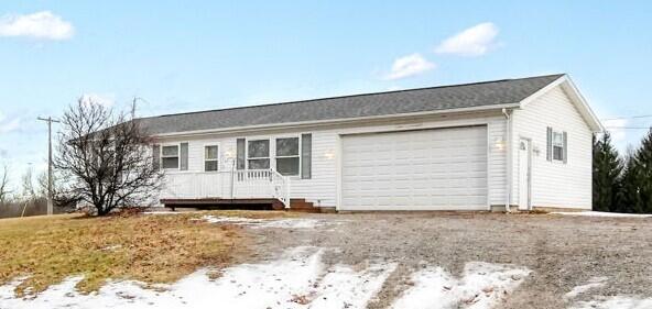 ranch-style home featuring an attached garage and driveway