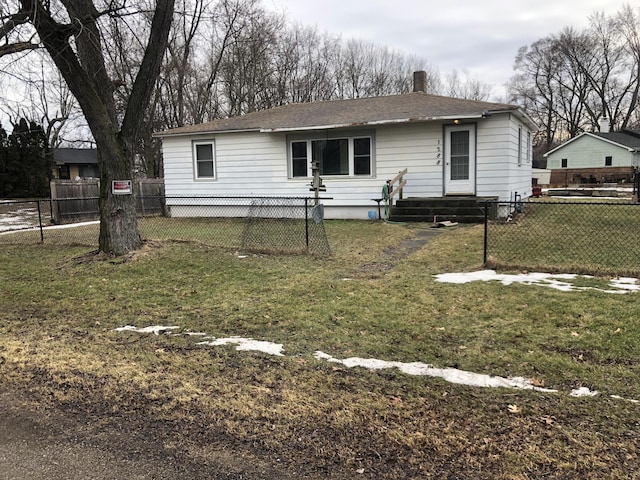 view of front of house with a front lawn and fence