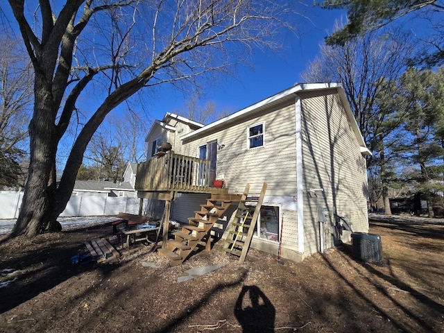 exterior space featuring cooling unit and fence