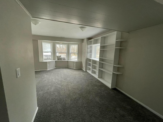 spare room with carpet and baseboards