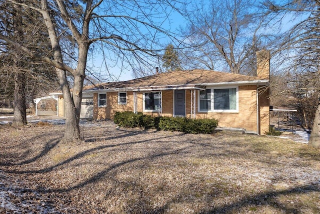 view of front of house with brick siding and a chimney