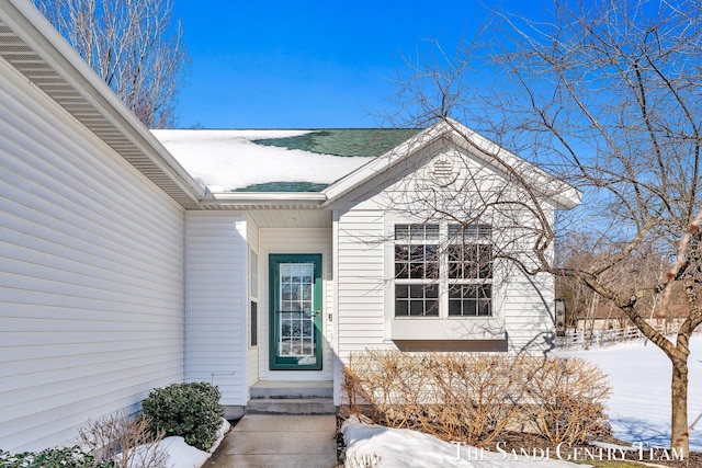 view of snow covered property entrance