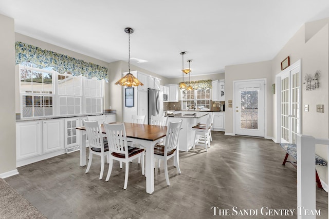 dining room with baseboards and dark wood finished floors