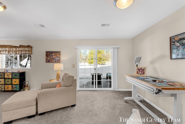 carpeted living room featuring visible vents and baseboards