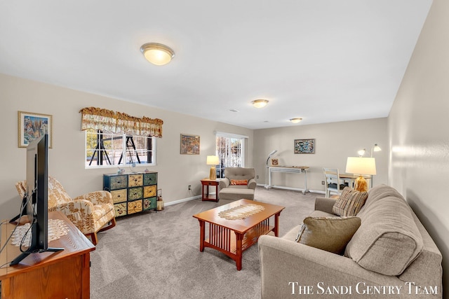 living room featuring carpet flooring and baseboards