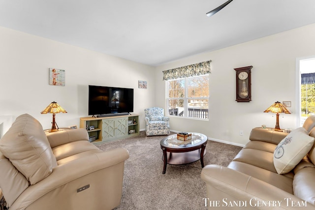 carpeted living area featuring baseboards