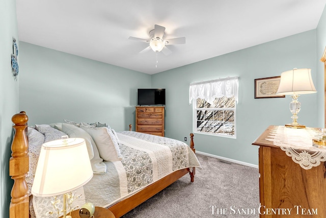 carpeted bedroom featuring ceiling fan, visible vents, and baseboards