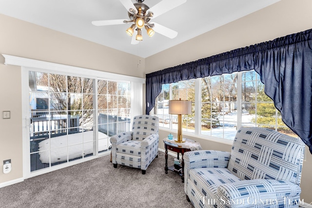 sitting room featuring ceiling fan, carpet floors, and baseboards