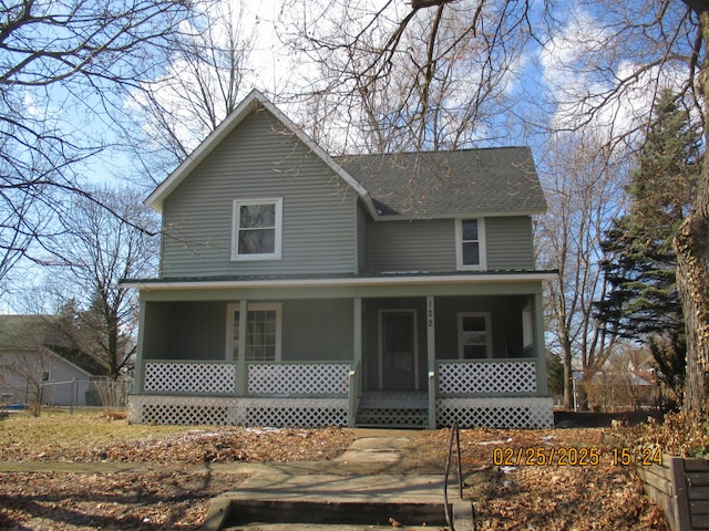 view of front of house with a porch and roof with shingles