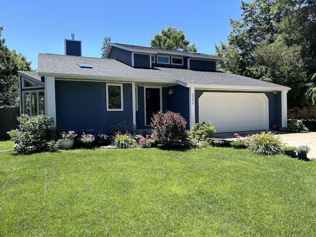 view of front of house featuring driveway, a chimney, roof with shingles, an attached garage, and a front yard