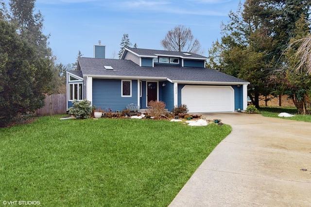 view of front of home with a chimney, a shingled roof, fence, driveway, and a front lawn