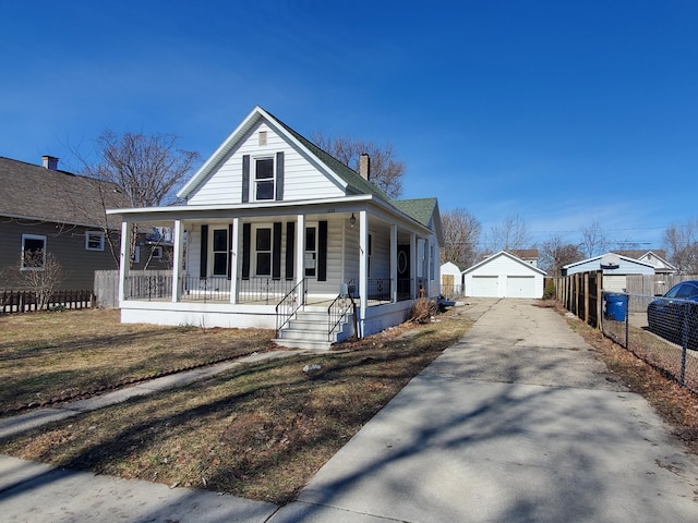 view of front of property with a porch, an outdoor structure, fence, a detached garage, and a chimney