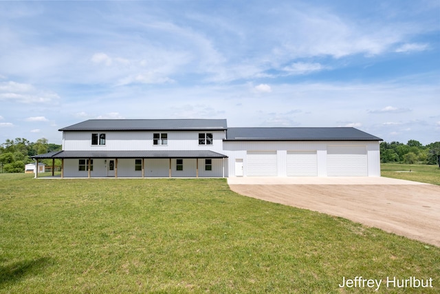 view of front of house featuring a front lawn, metal roof, and dirt driveway