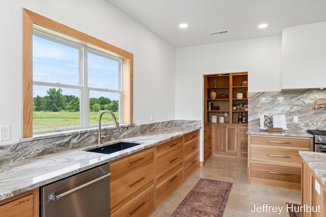 kitchen with tasteful backsplash, visible vents, light stone countertops, stainless steel appliances, and a sink