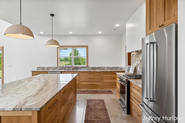 kitchen featuring high end appliances, recessed lighting, tasteful backsplash, a sink, and light stone countertops