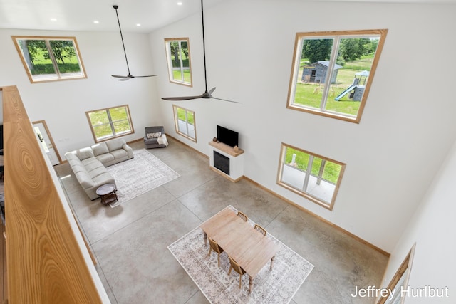 living area with baseboards, high vaulted ceiling, a ceiling fan, and recessed lighting