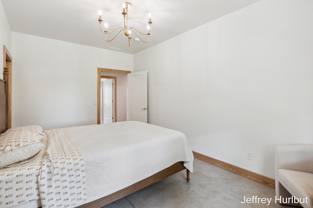 bedroom with a chandelier and baseboards