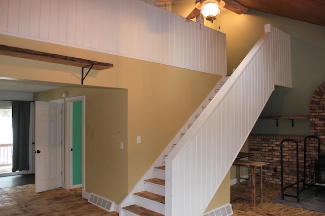 stairs with visible vents, ceiling fan, baseboards, and wood finished floors