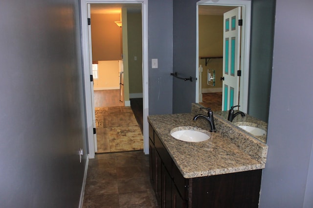 bathroom with baseboards and vanity