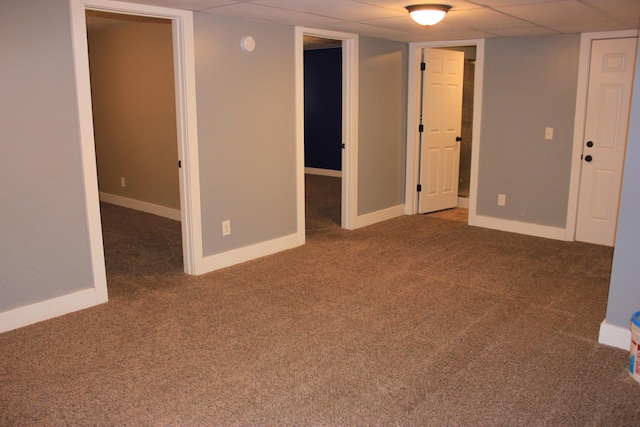 finished below grade area with carpet floors, a paneled ceiling, and baseboards