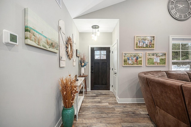 entryway featuring baseboards and wood finished floors