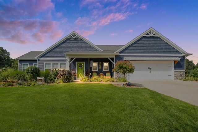21889 Hilltop Cir, Stanwood, MI 49346 - view of front of property with a front lawn, concrete driveway, an attached garage, and stone siding