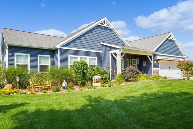 21889 Hilltop Cir, Stanwood, MI 49346 - rear view of house featuring a yard, a garage, roof with shingles, and board and batten siding