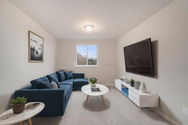 carpeted living area featuring visible vents and baseboards