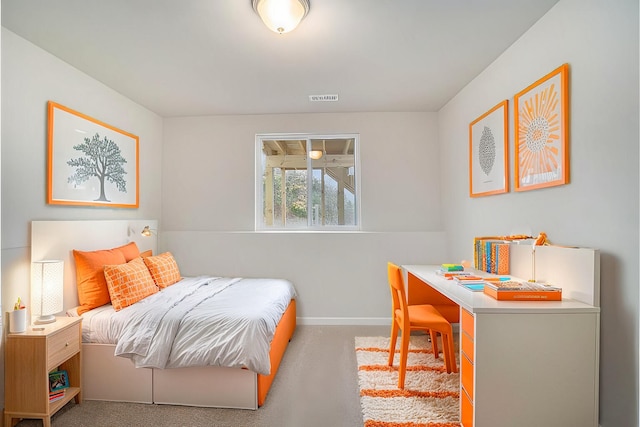 bedroom with visible vents, light carpet, and baseboards