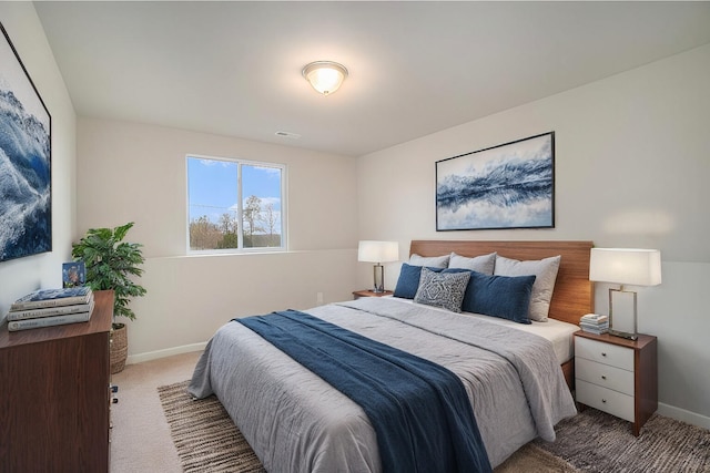 bedroom with carpet floors, visible vents, and baseboards