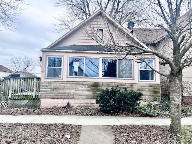 view of side of home with stone siding